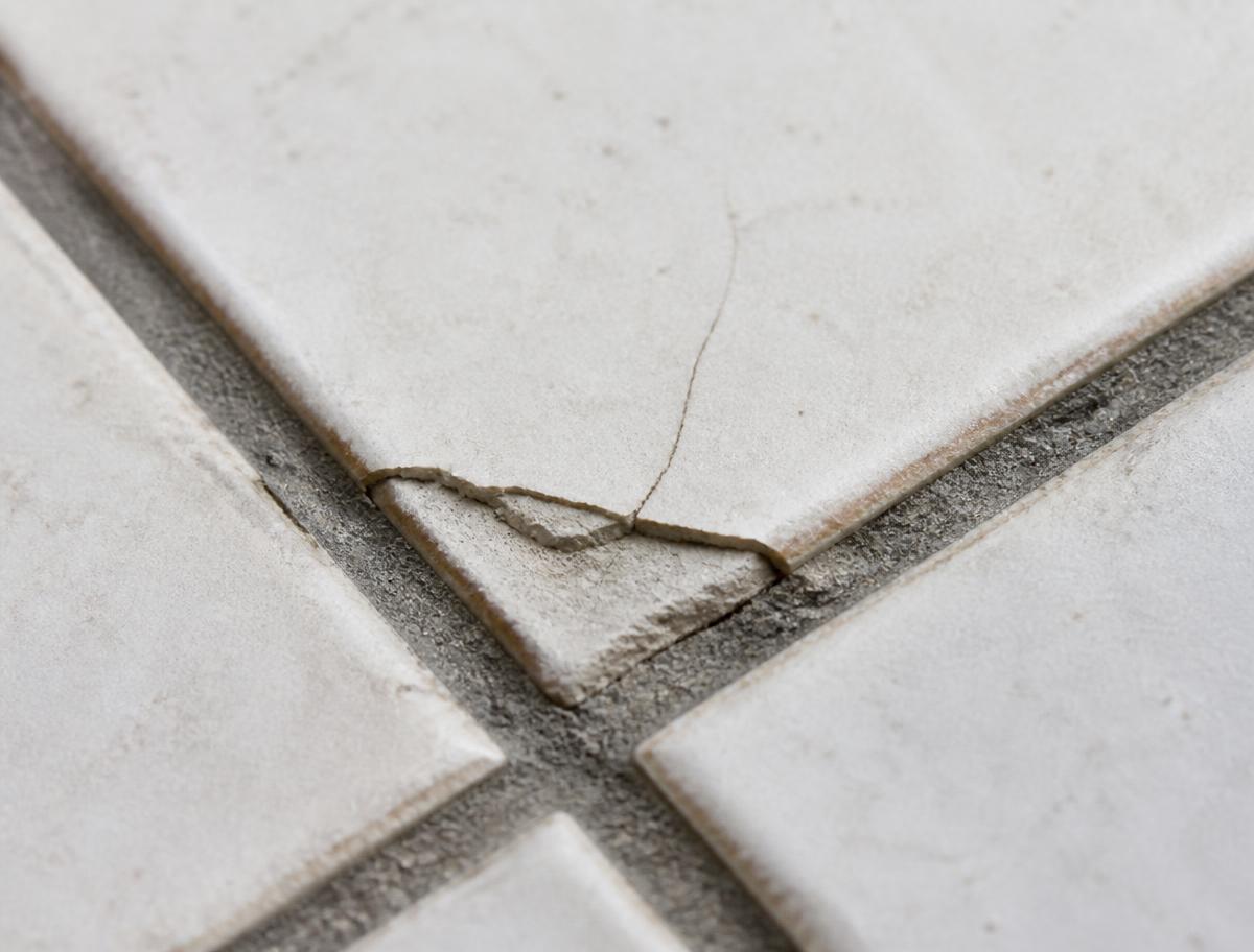 Ceramic tile with a chipped, cracked corner before repair